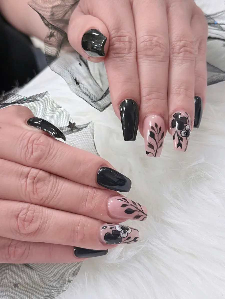 Glossy black nails with nude floral accent art by V Nails Lacombe