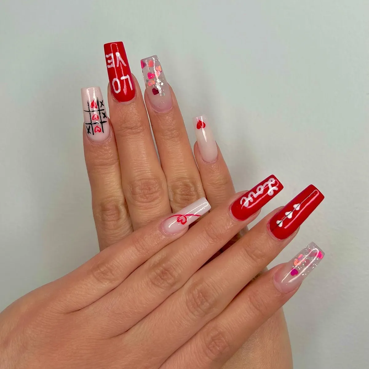 Red and white Canada-inspired nail art by V Nails Lacombe