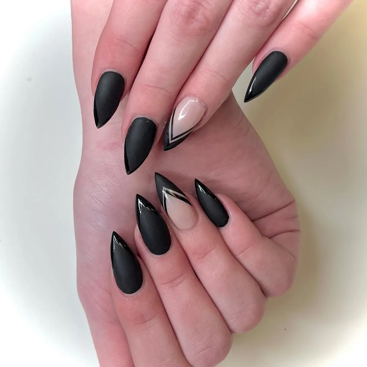 Matte black almond nails with nude geometric accents by V Nails Lacombe