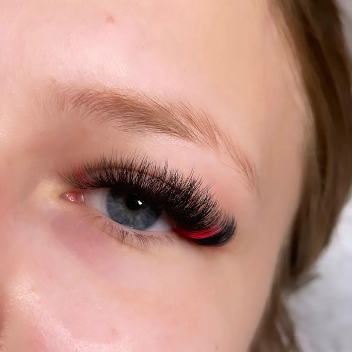 Black volume lashes with scarlet outer accents by V Nails Lacombe