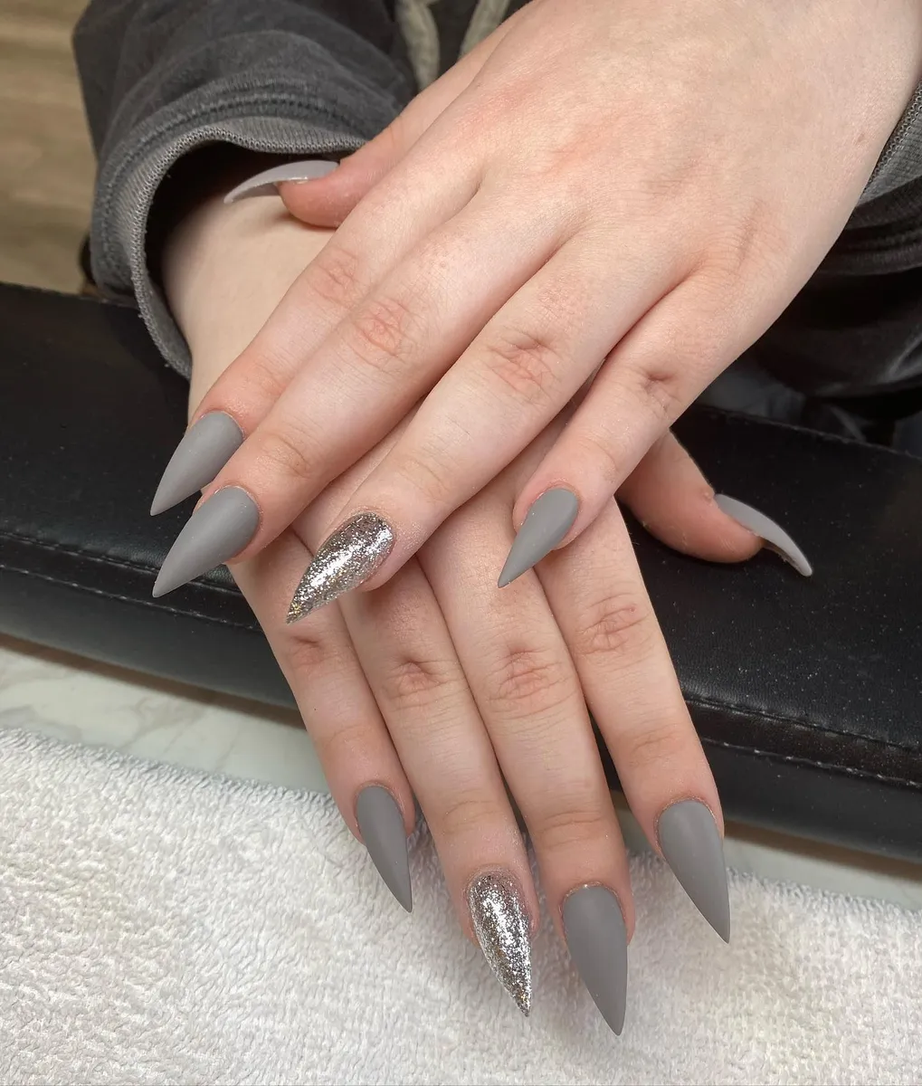 Smoky grey stiletto nails with silver glitter accents by V Nails Lacombe